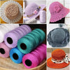 Rolls of 1.5mm cotton silk thread used for knitting and crafting, shown in various colors and used to make hats.