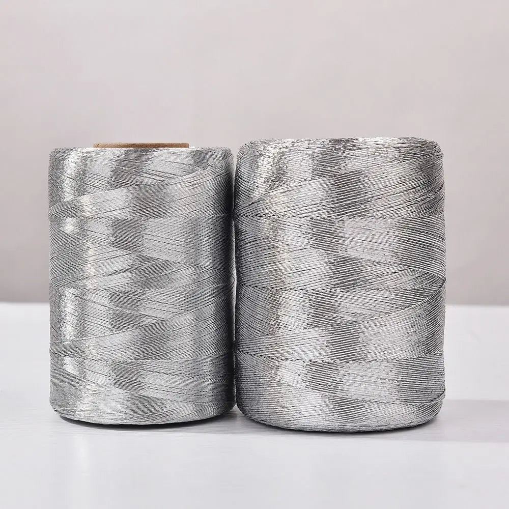 Two spools of silver glitter metallic yarn for crafting