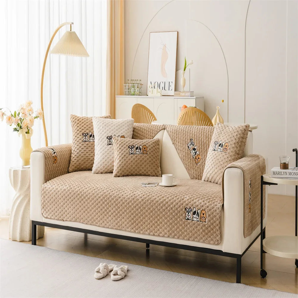 A beige plush sofa cover with decorative stitching and animal motifs displayed on a modern sofa.