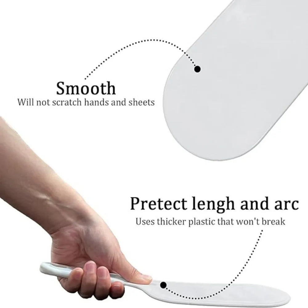 A hand demonstrates the smooth, durable plastic tool used for bed sheet folding and organizing.