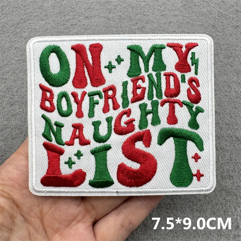 A white embroidered patch featuring the text ON MY BOYFRIEND'S NAUGHTY LIST in red and green thread.
