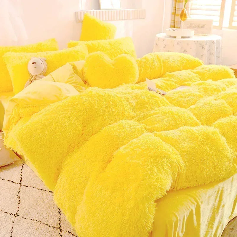 A bright yellow plush mink velvet duvet set with fluffy pillows on a bed.