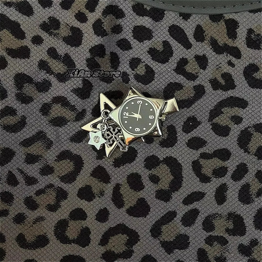 Silver star-shaped pocket watch keychain with an adjustable clock face set against a leopard print fabric background