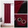 Solid black blackout privacy curtains in deep red fabric with silver grommets shown hanging on a rod.