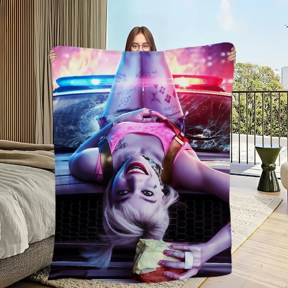 A woman lies on a bed with an open book featuring a vibrant pink and purple background.
