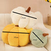 Two plush pumpkins, one white and one yellow-green, are shown with measurement lines.