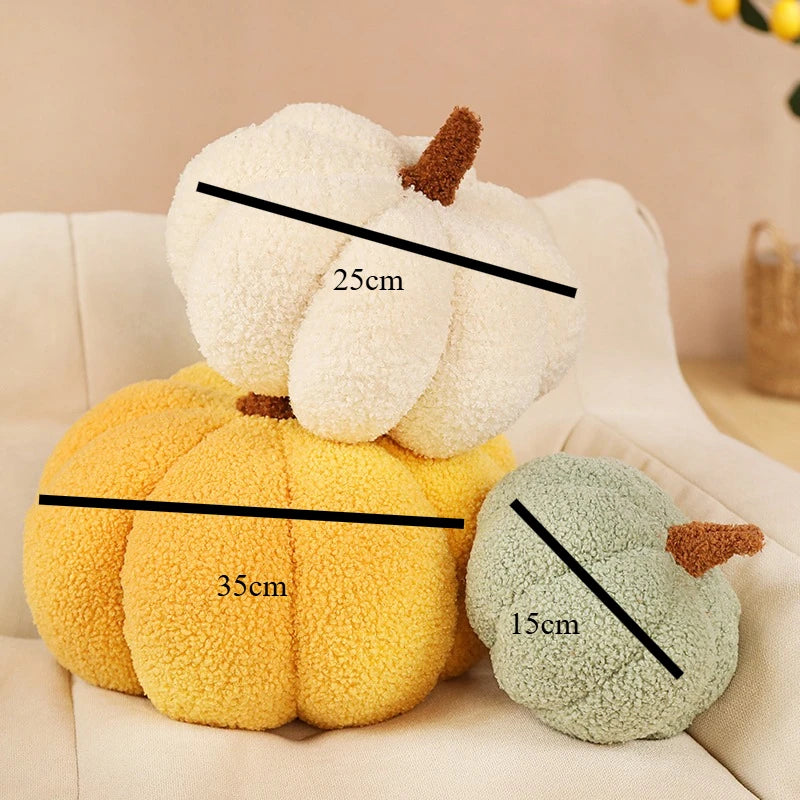 Two plush pumpkins, one white and one yellow-green, are shown with measurement lines.