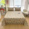 Light floral print flat bed sheets on a double bed with white and pink decor.
