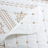 White Nordic cotton bedding featuring delicate brown embroidery patterns.