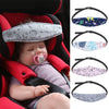 A baby is shown in a red car seat with an adjustable head support pillow and a matching fabric headband.