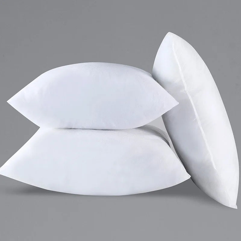 Two white throw pillow inserts with bounce-back support stacked on a gray background