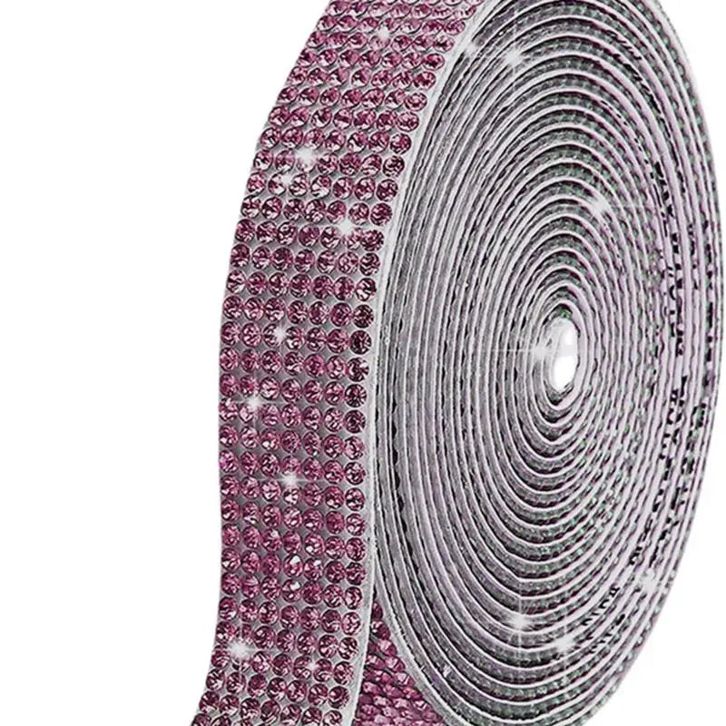 Close-up of a crystal rhinestone sticker ribbon with diamond trim in pink and silver tones.