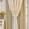 A close-up of a cream and gold dual-layer curtain with eyelet detailing and gathered fabric.