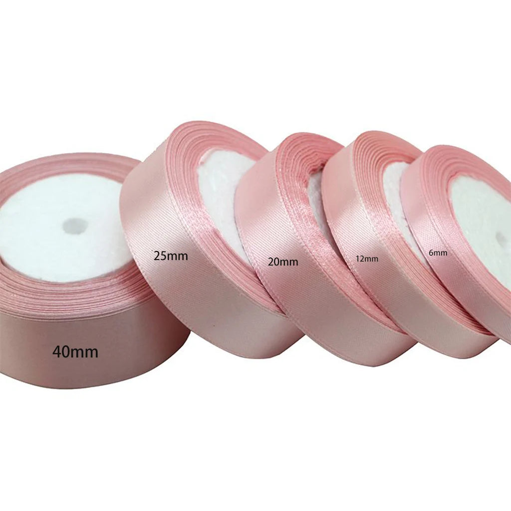 Rolls of light pink satin gift ribbon measuring 40mm, 25mm, 20mm, 12mm, and 6mm wide.