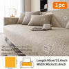A beige sofa cushion with matching pillows displayed on a bed, showing the texture and size.
