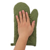 A hand is holding a green insulated heat resistant cooking gloves set.
