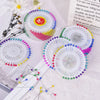 A collection of pearl head pins in various colors and sizes for sewing and crafting.