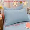 A light blue matte solid color pillowcase is displayed on a bed, with decorative star lights in the background.
