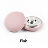A pink round fabric-covered shank button is shown next to its silver metal base.