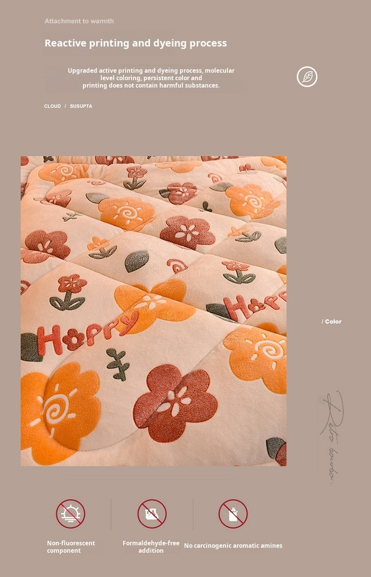 A close-up of a soft, peach-colored blanket featuring floral embroidery in shades of orange and pink.