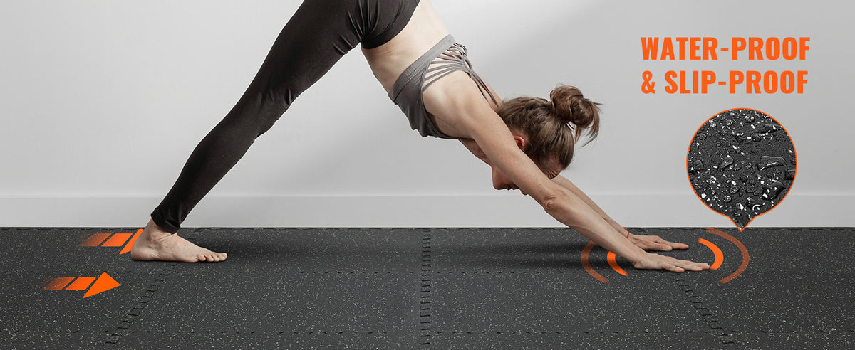 A person performing a yoga pose on a dark fitness floor mat with orange sensor lights.
